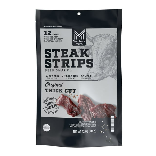 member's mark beef steak strips, 12 oz. resealable bag front-facing pack with 'STEAK STRIPS' label, Member's Mark logo and cow illustration, photo of extra thick-cut naturally smoked beef strips; packaging shows 100% beef, 96% fat-free, nine grams protein, gluten-free and net wt. 12 oz.; often used as a portable jerky snack for hiking or travel.