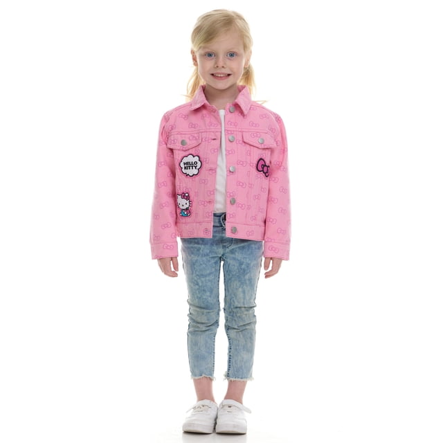 character toddler girl denim jacket Hello Kitty pink button-up long-sleeve denim jacket, front-facing on a standing toddler in light-wash jeans; collared, waist-length fit with visible Hello Kitty face and speech-bubble patches and repeated bow print across the fabric.