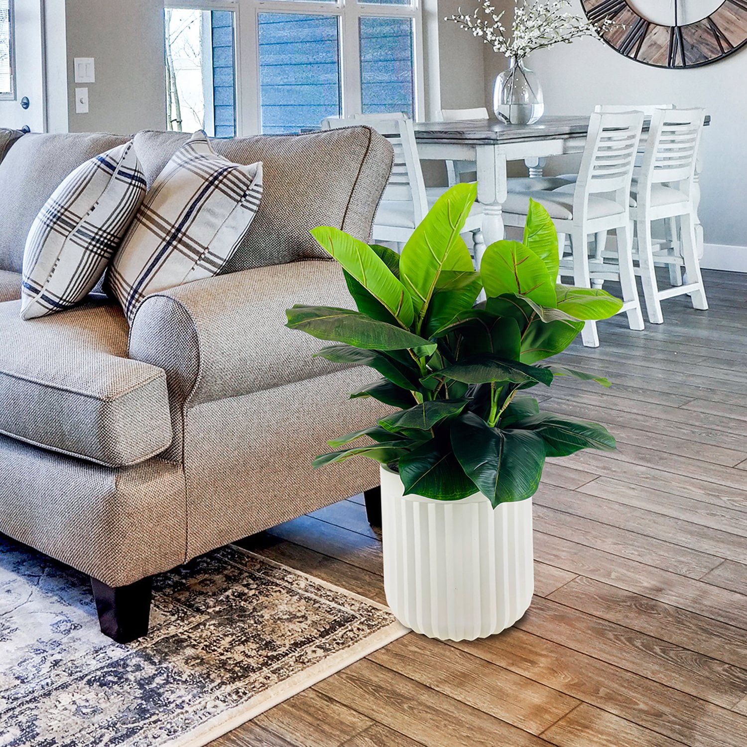 An obviously plastic-looking artificial plant with unnaturally uniform, shiny leaves in a living room corner
