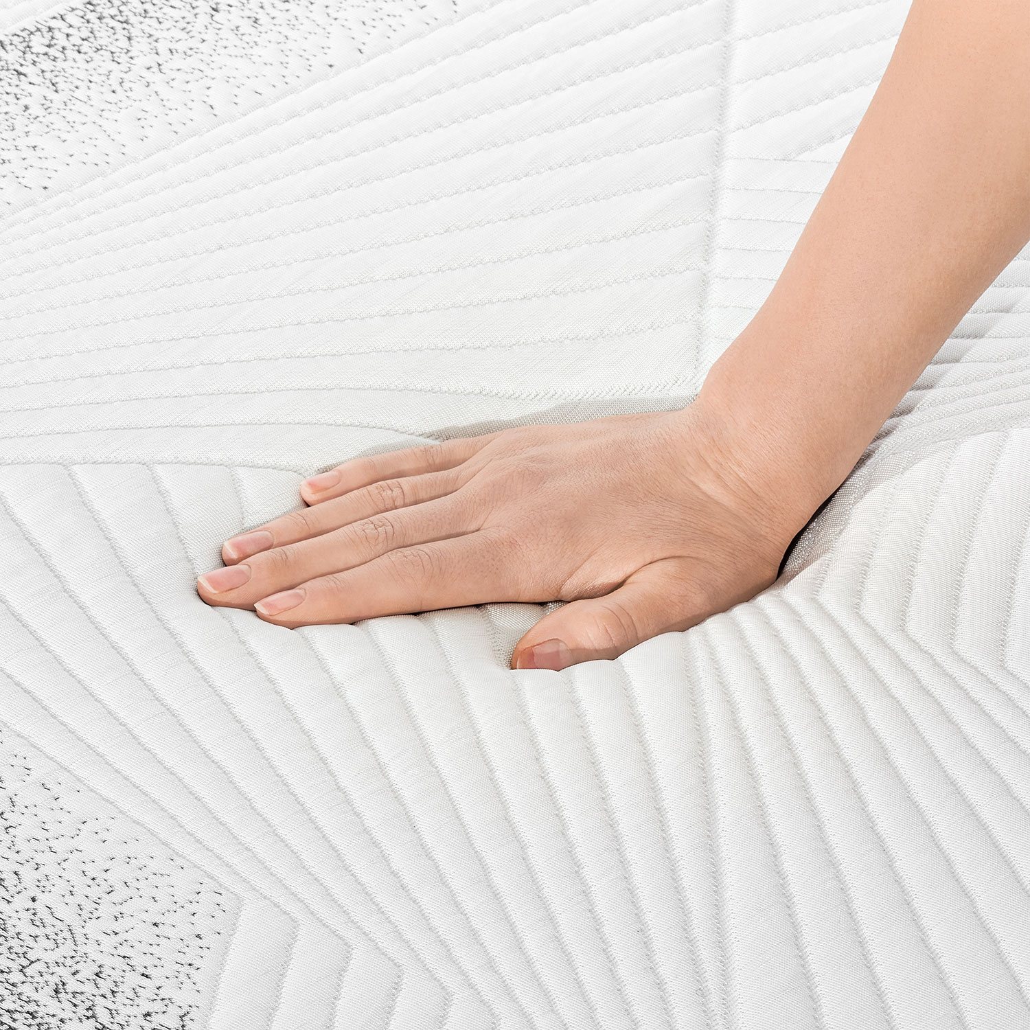 Close-up of mattress fabric being pressed with hand