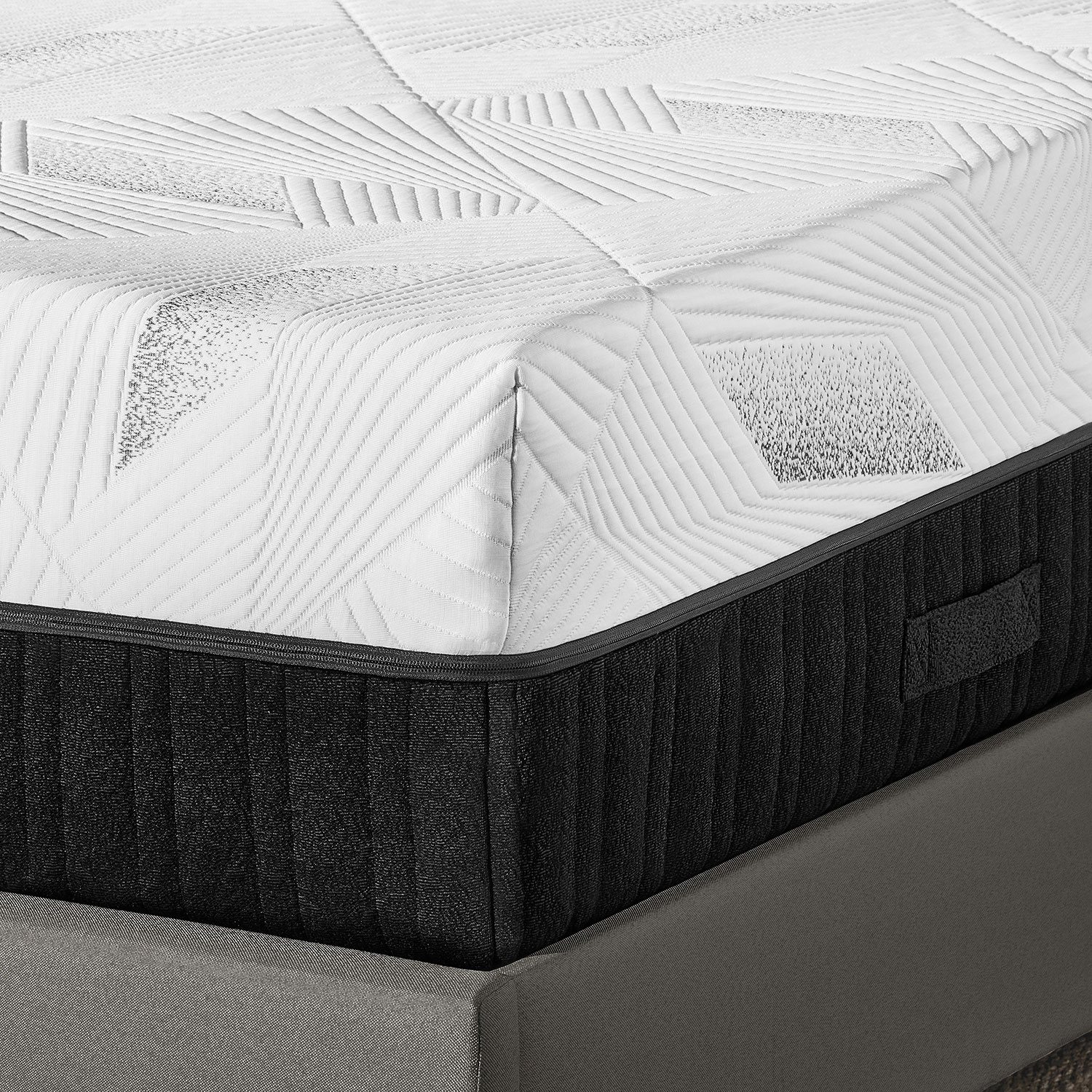 Close-up of mattress surface showing quilted pattern and corner seam